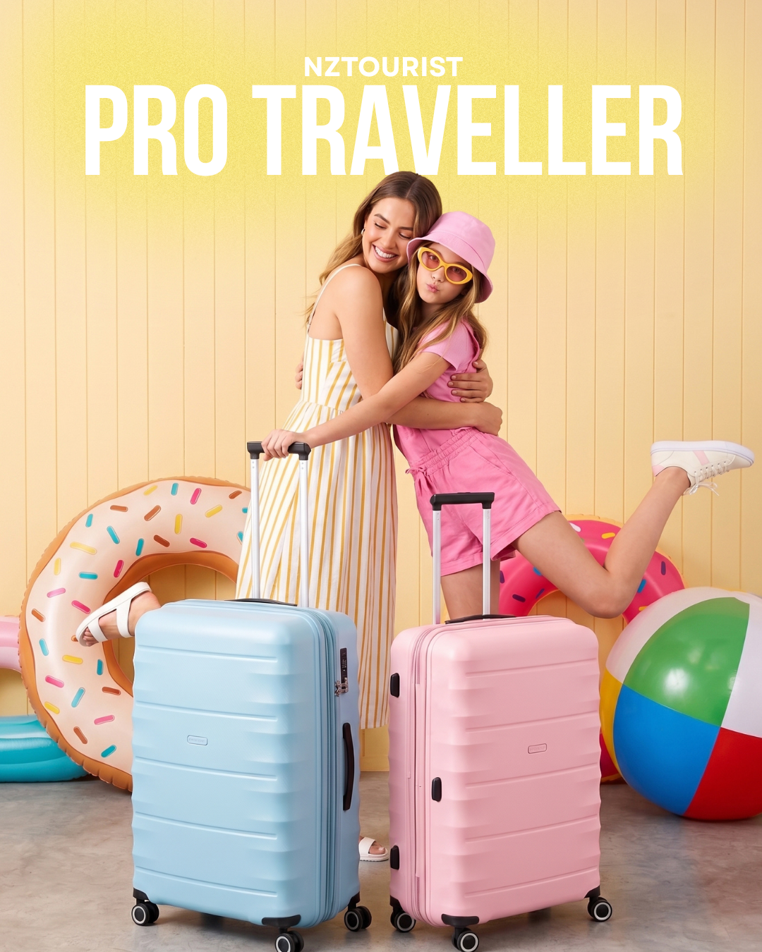 A mother and daughter hugging behind light blue and pink NZ Tourist Pro Traveller 65cm luggage against a yellow background.
