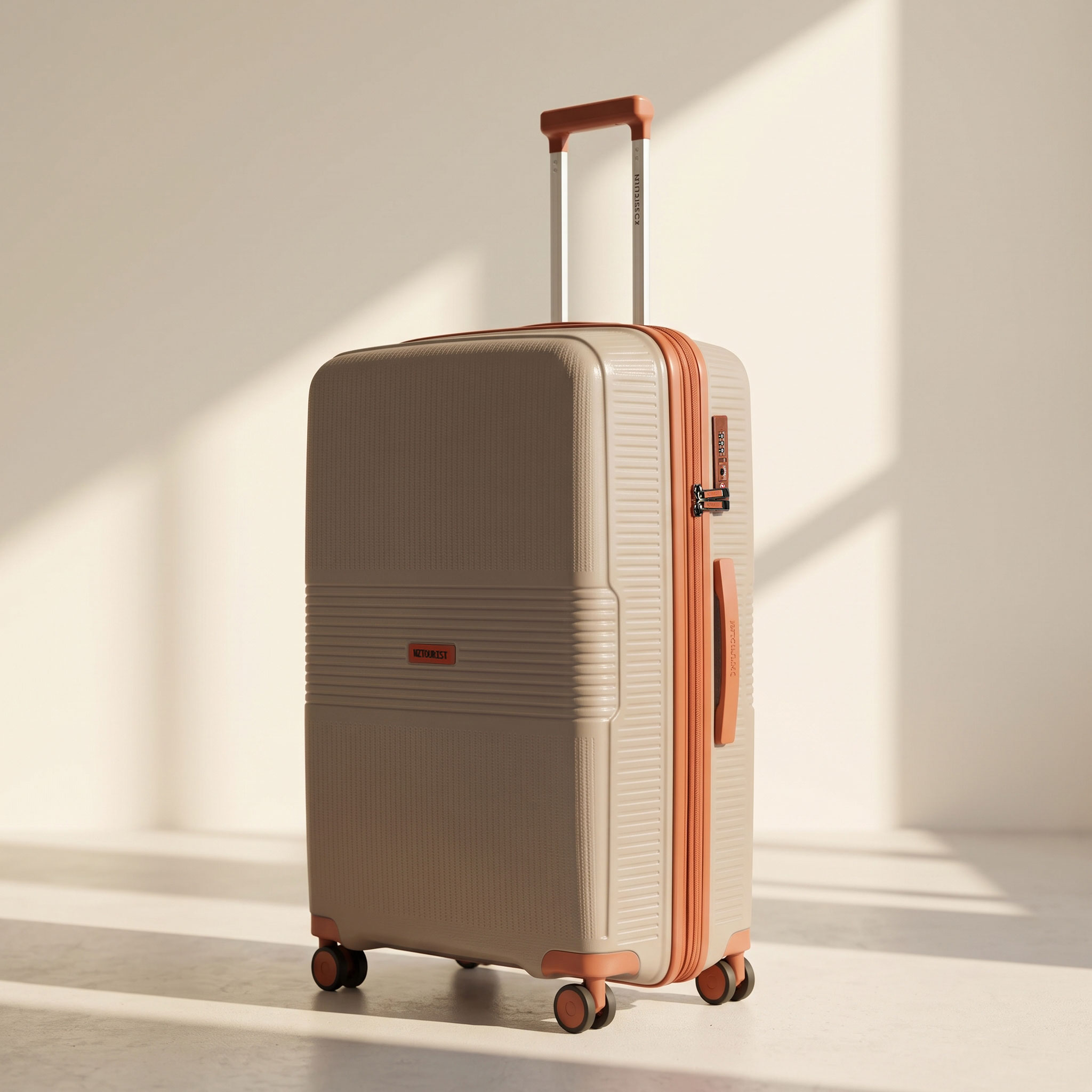 Large checked suitcase in taupe with orange trim in a sunlit studio