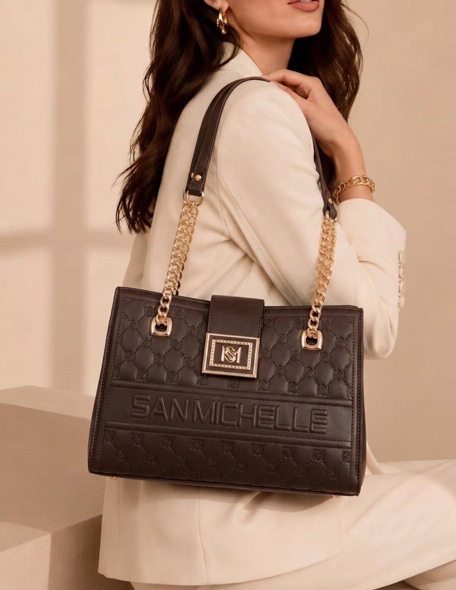 Woman carrying a quilted San Michelle tote bag in coffee brown